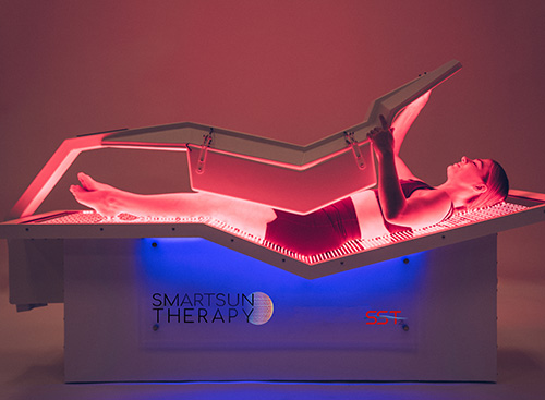 Relaxing in a red light therapy session